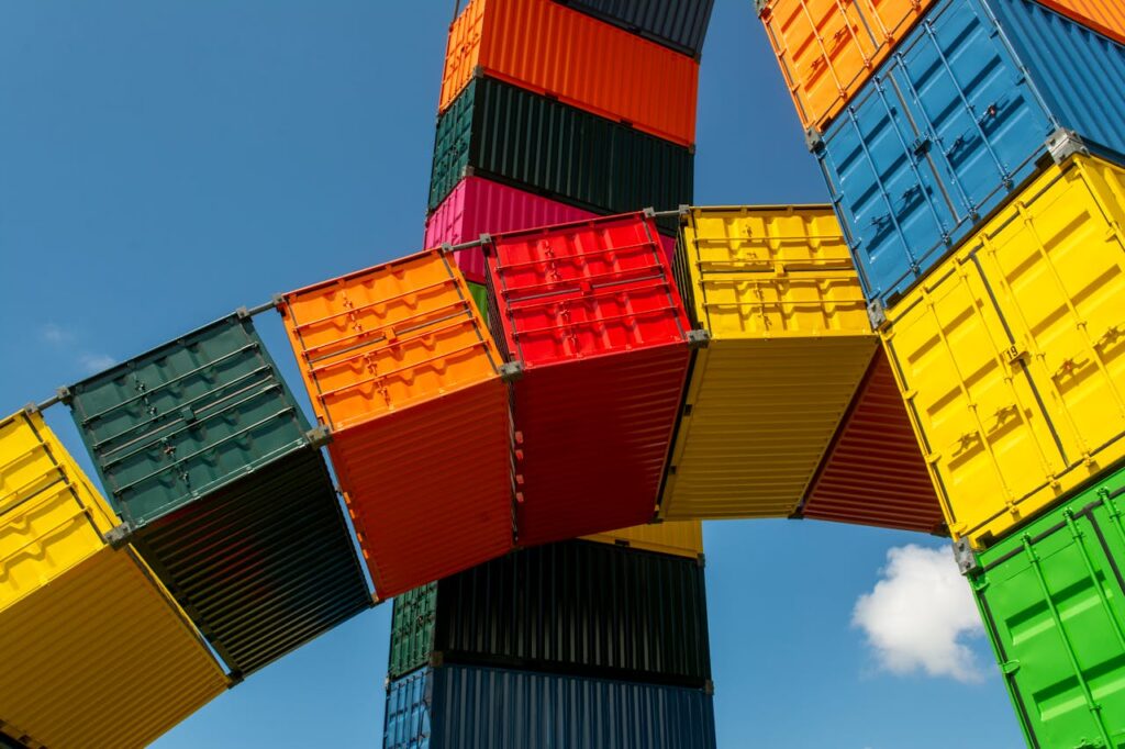 Striking sculpture made of vibrant colored shipping containers under a blue sky in Le Havre, France.